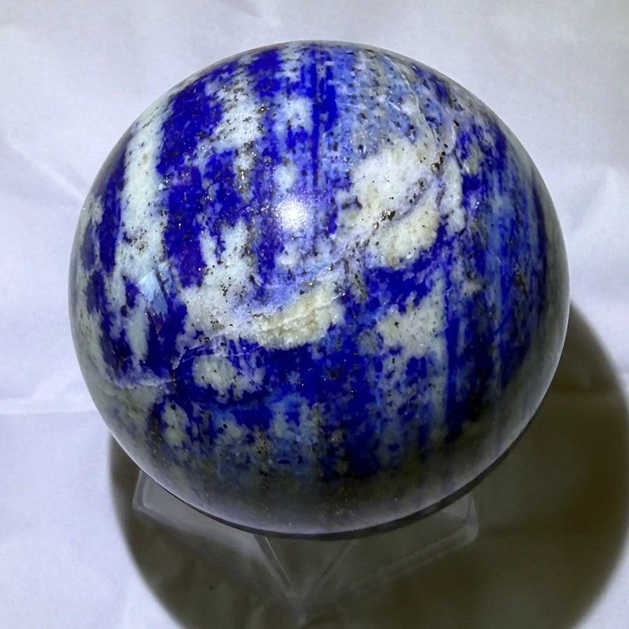lapis lazuli carved sphere with natural fractures, lots of pyrite and deep blue