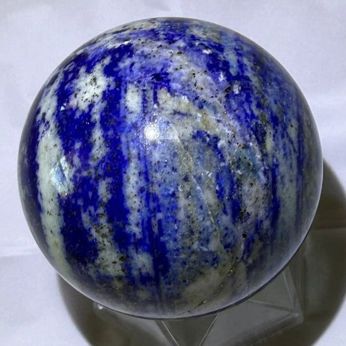 natural lapis lazuli sphere with deep blues, light blues, pyrite and white banding and inclusions
