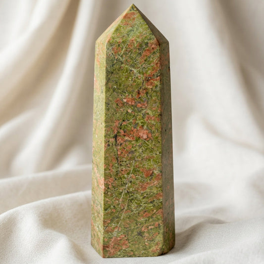 close up photo of a pink and green natural unakite crystal hexagonal tower