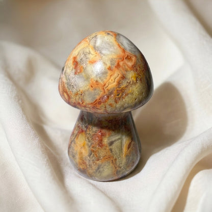 close up of earth tone swirls polychrome jasper carving resembles a mushroom