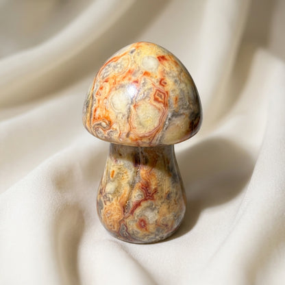 close up showing bright yellows, copper colors natural swirls, polychrome jasper mushroom.  hand carved