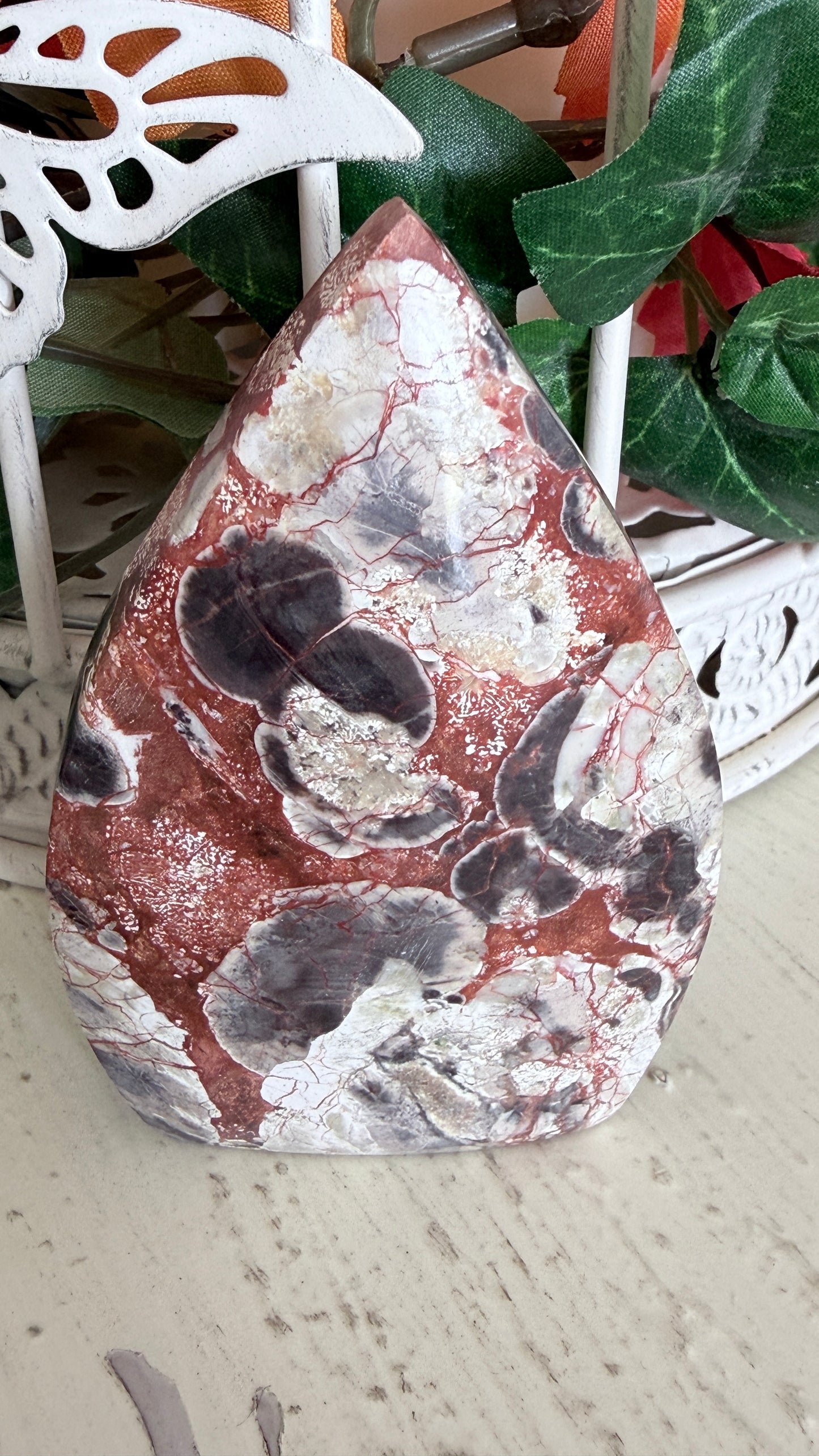 Brecciated Jasper TearDrop with intricate red and white patterns, displayed on a white surface