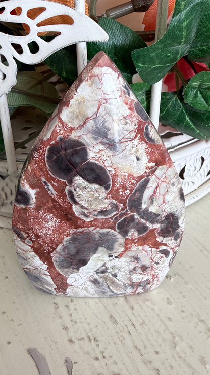 Brecciated Jasper TearDrop with intricate red and white patterns, displayed on a white surface