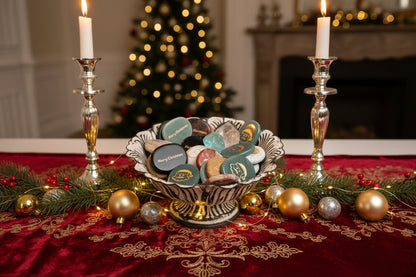 Decorative Bowl with Christmas Themed genuine crystal worry stones. Decorated for the holidays engraved with gold lettering, Santa, merry Christmas 