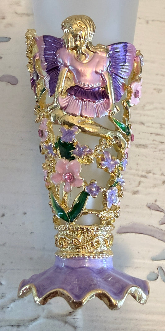 close up of fragrance bottle showing pink and purple fairy with flowers and rhinestones  frosted bottle