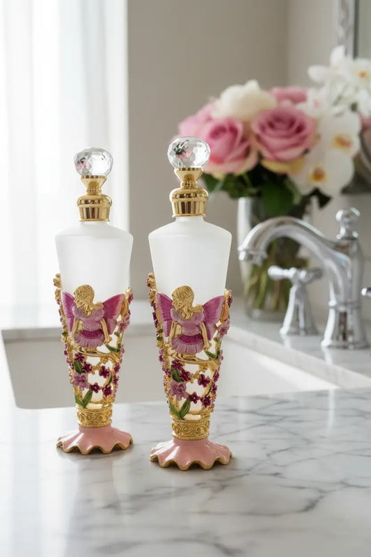 pretty fragrance bottles on a marble bathroom counter with flowers behind