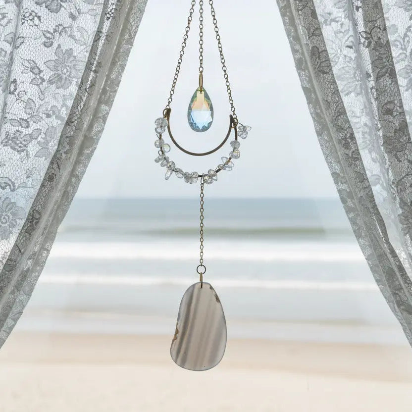 Clear Quartz and Agate Suncatcher Crystal Window Prism on wooden background