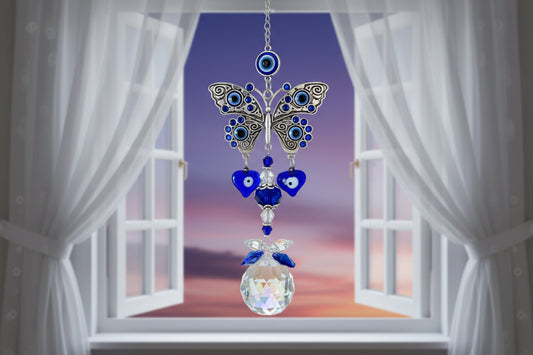 Blue Evil Eye Butterfly Suncatcher with crystal prism in a window