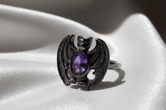 Black color alloy adjustable bat shaped ring with purple, amethyst stone