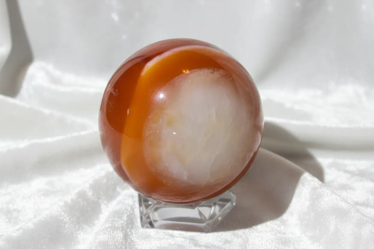 Carnelian sphere with quartz inclusions and druzy pocket