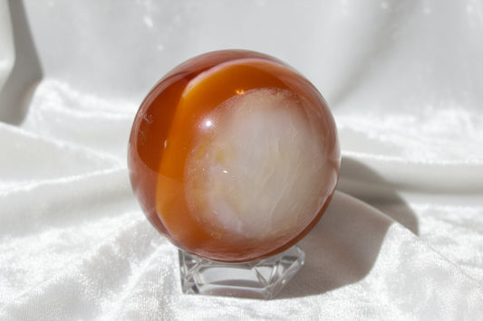 Carnelian Sphere with quartz inclusions and druzy pocket