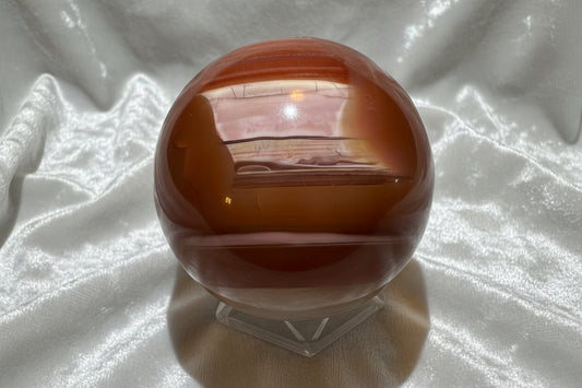 Carnelian sphere with white fabric behind