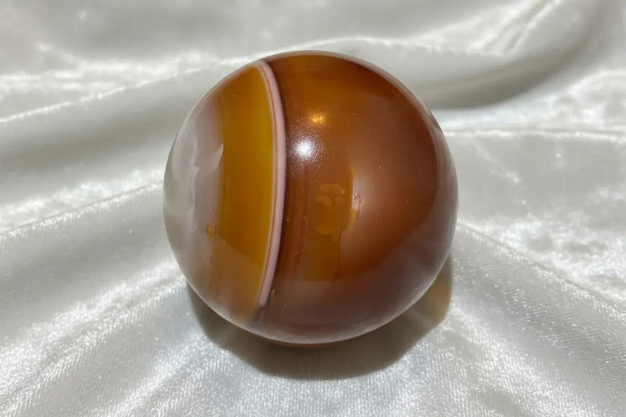 Carnelian sphere side view with orange banding