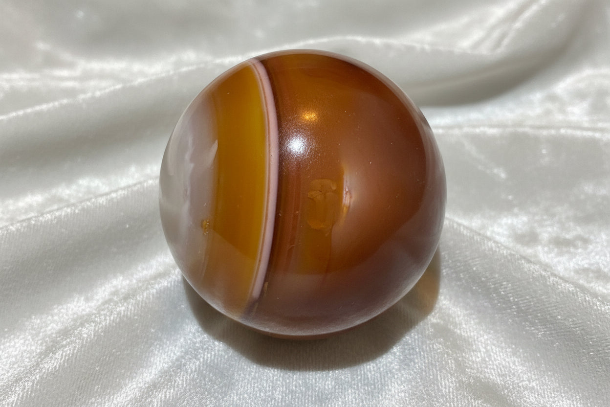 Carnelian sphere side view with orange banding