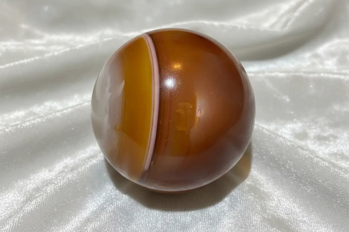 Carnelian sphere side view with orange banding