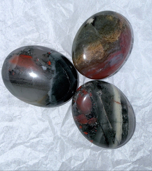 Three bloodstone crystal palm stones. beautiful colors black, red, tan, browns 