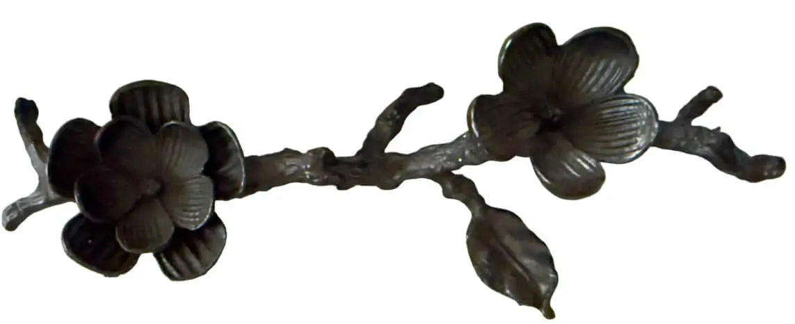 Close up of a black iron double space sphere stand. The spheres sit in flowers created in the black iron 