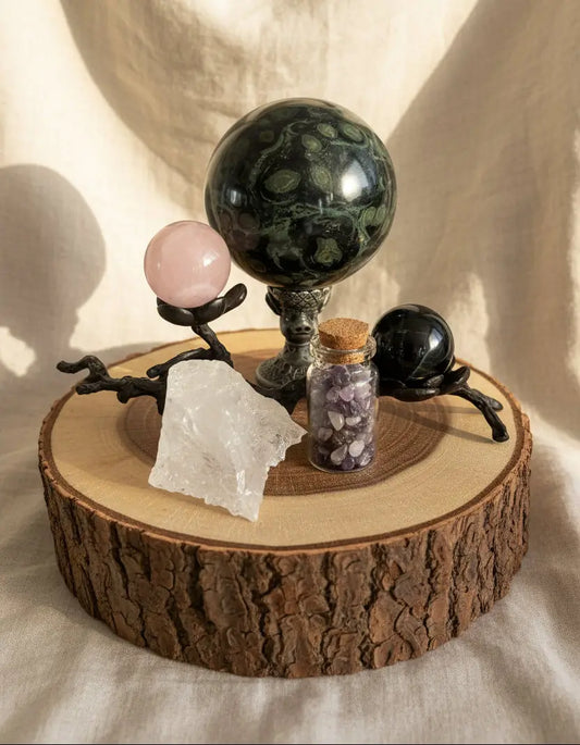 Kambaba Jasper Sphere, rose quartz and tiger’s eye spheres on a black stand, wish jar with amethyst chips, raw clear quartz specimen and the chinese symbol pig sphere stand represents wealth, prosperity and good fortune