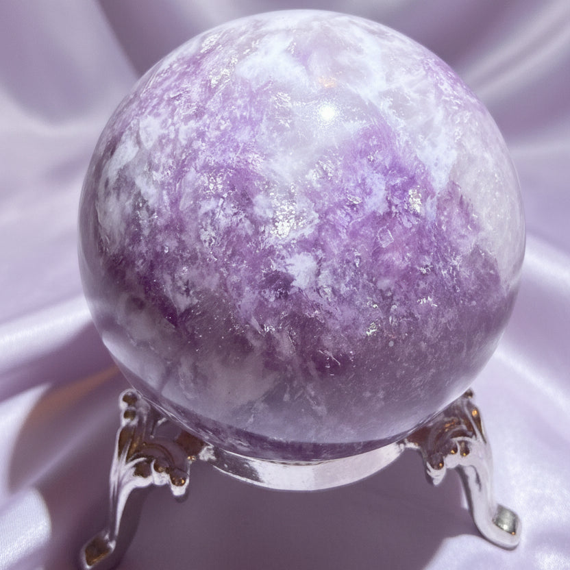 Lepidolite Sphere on a stand with a light lavender fabric background