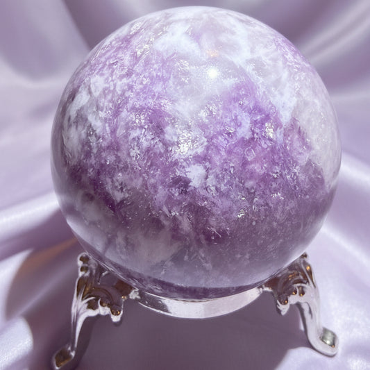 Lepidolite Sphere on a stand with a light lavender fabric background