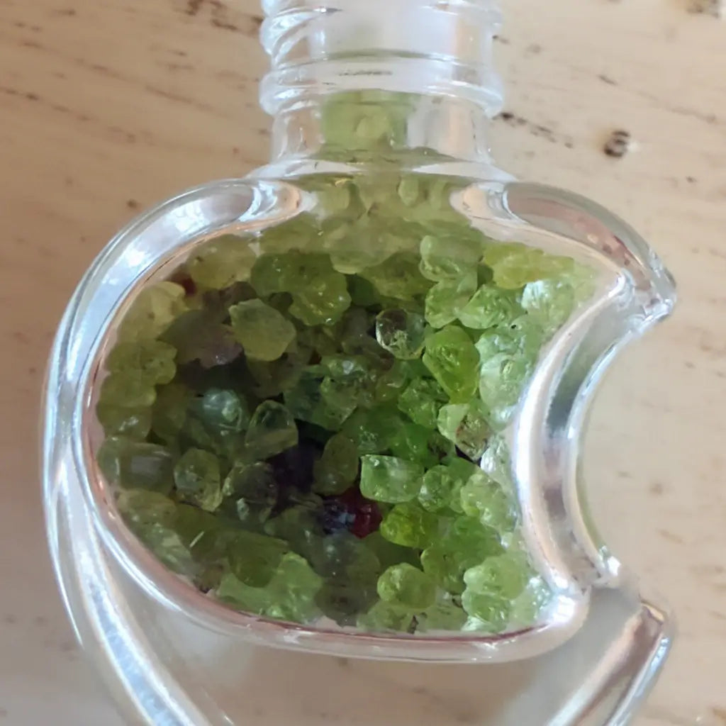 Clear, moon shaped wish bottle filled with Aventurine Chips