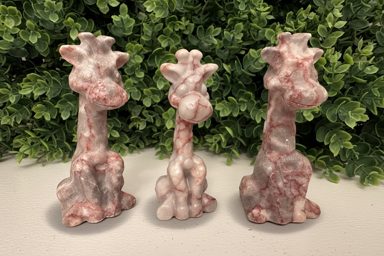 3 giraffes carved from red vein jasper crystal Bright pink iron oxide pigments 