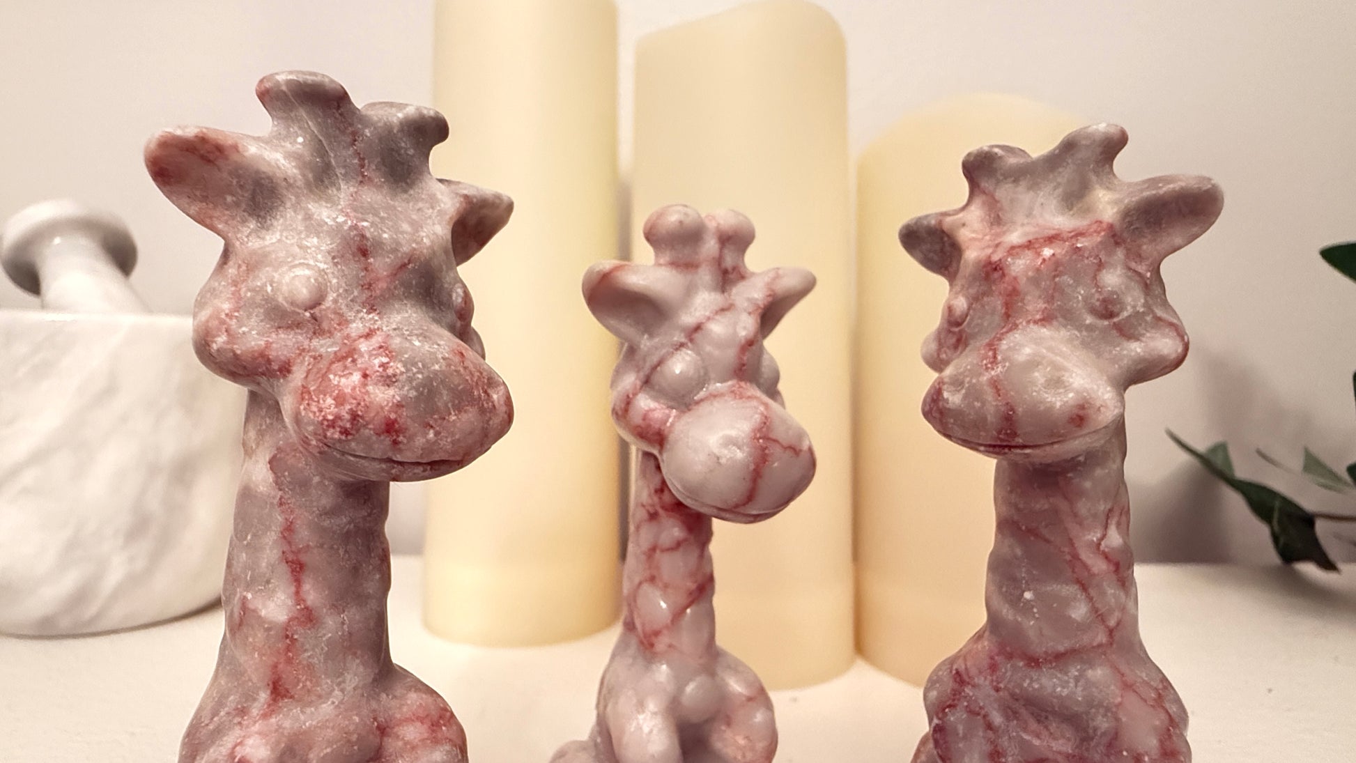 Three small giraffe figurines Carved from Red Vein Jasper Crystal Bright Pinks from the Iron Oxide inclusions