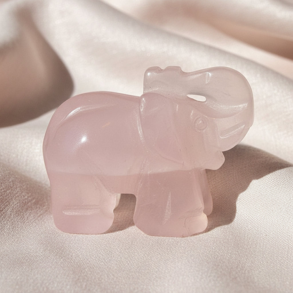 A carved elephant rose quartz crystal