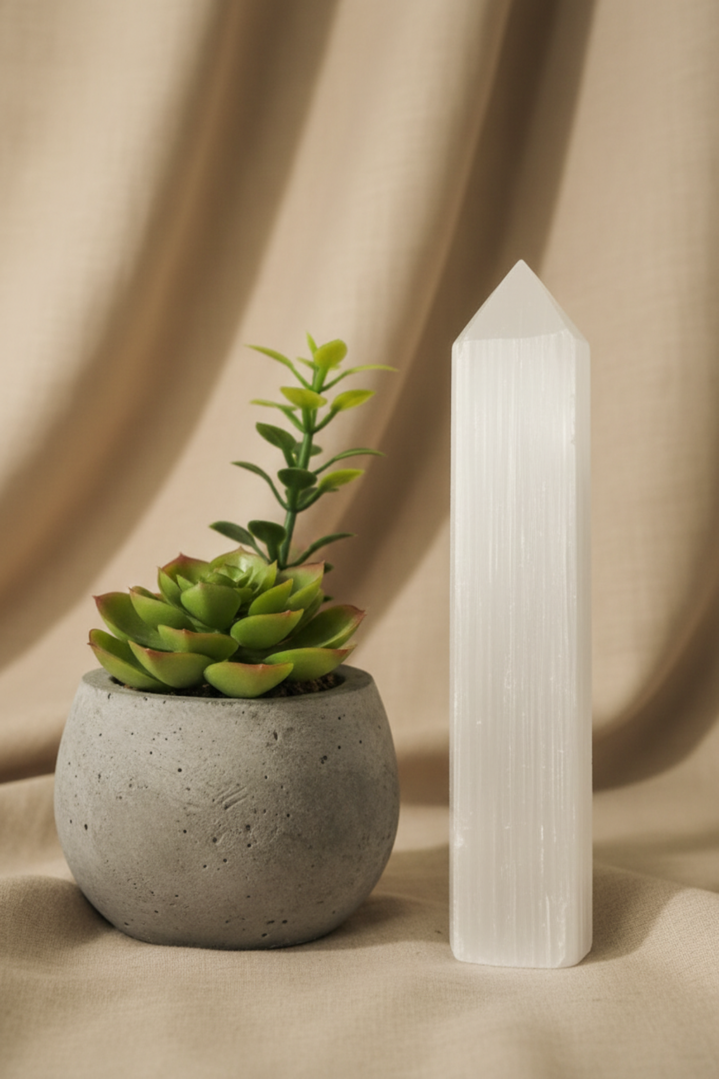Warm tones, satin spar tower with plant and brown bsckground 
