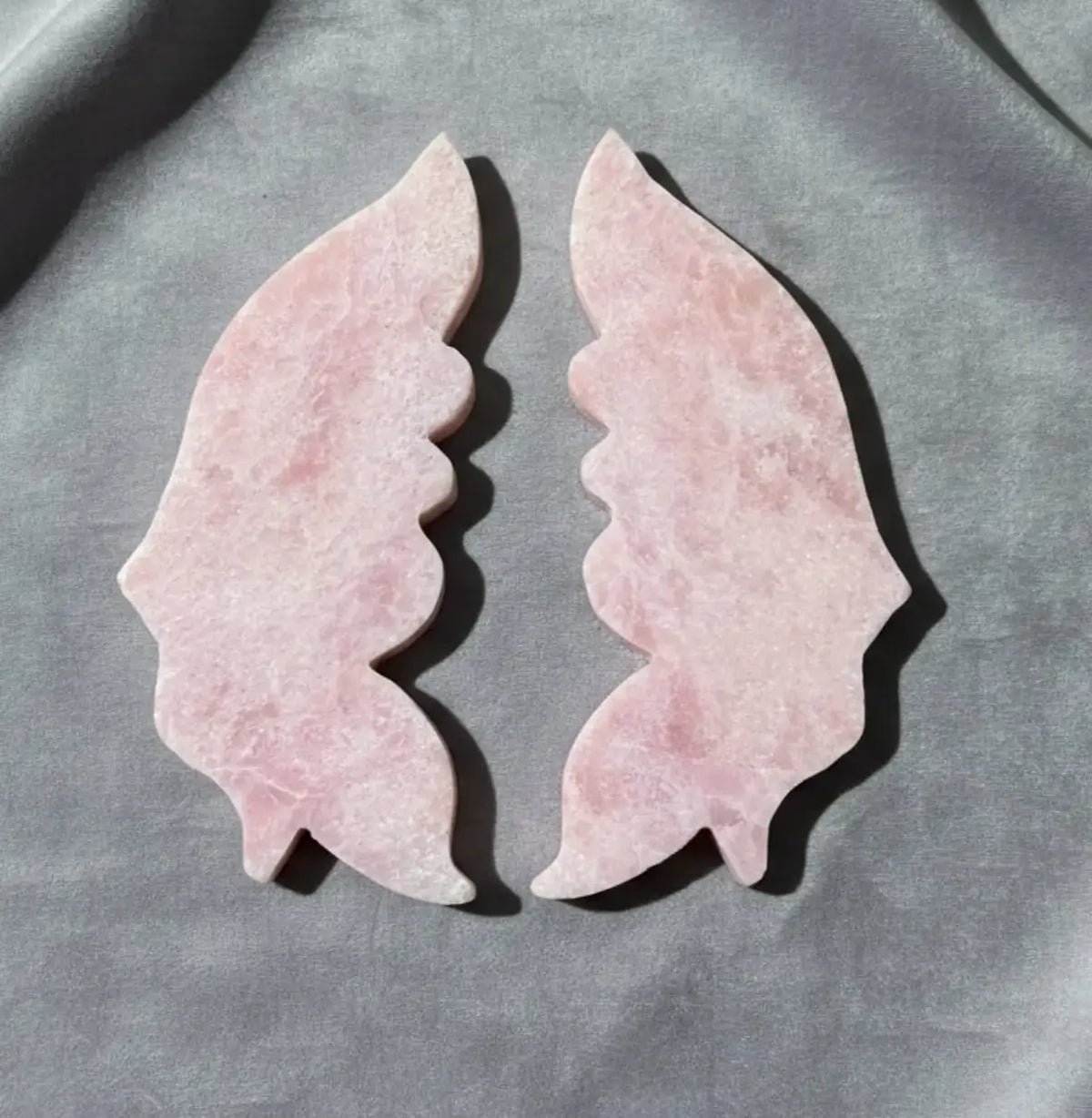 Back side photograph pink opal carved wings back has no carved lines 