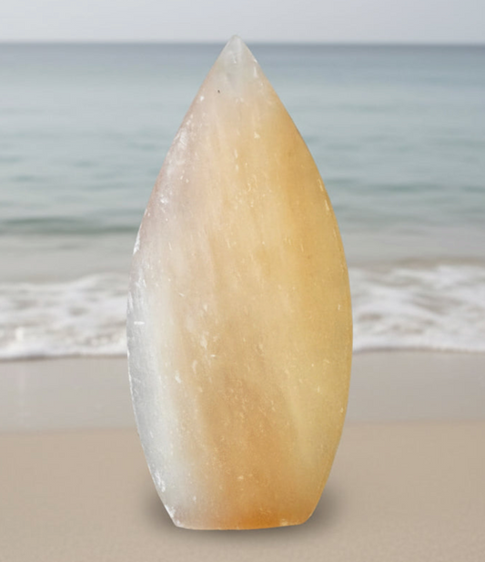 Peach Selenite freeform with a beach waves background