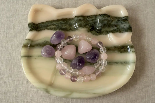 over head shot of hello kitty carved zebra onyx trinket bowl (tumbles and bracelets not included)