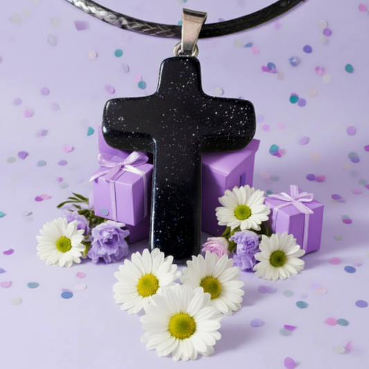 Sandstone crystal carved cross pendant background lavender party with confetti and flowers 