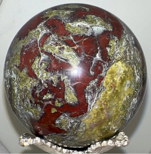 Dragons Blood Sphere on a Silver Stand deep burgundy, yellow and greens