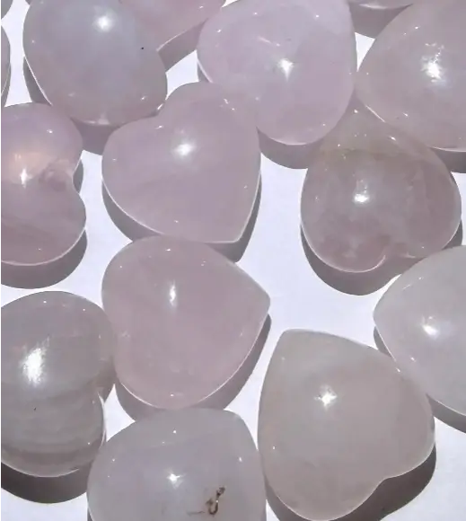Close up Petite Rose Quartz Carved Hearts. 