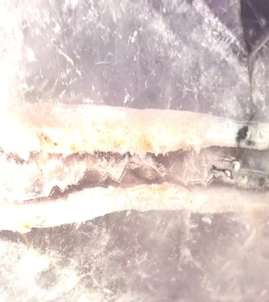 photo magnified view amethyst with enclosed druzy pocket, quartz trapped inside 