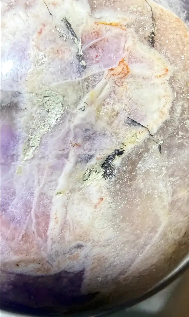 magnified close up beautiful amethyst sphere natural inclusions, quartz inclusions with iron rich rutile trapped inside 
