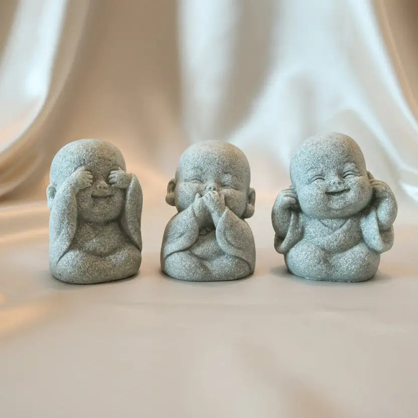three sandstone carved buddha figurines see no, hear no, speak no proverb 