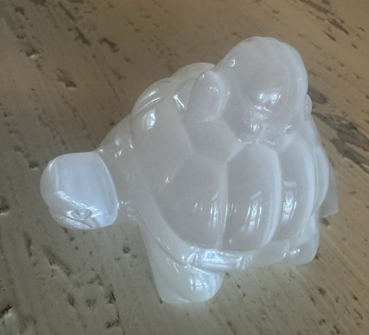 Selenite Polished Carving of two Turtles sitting on a rustic table 