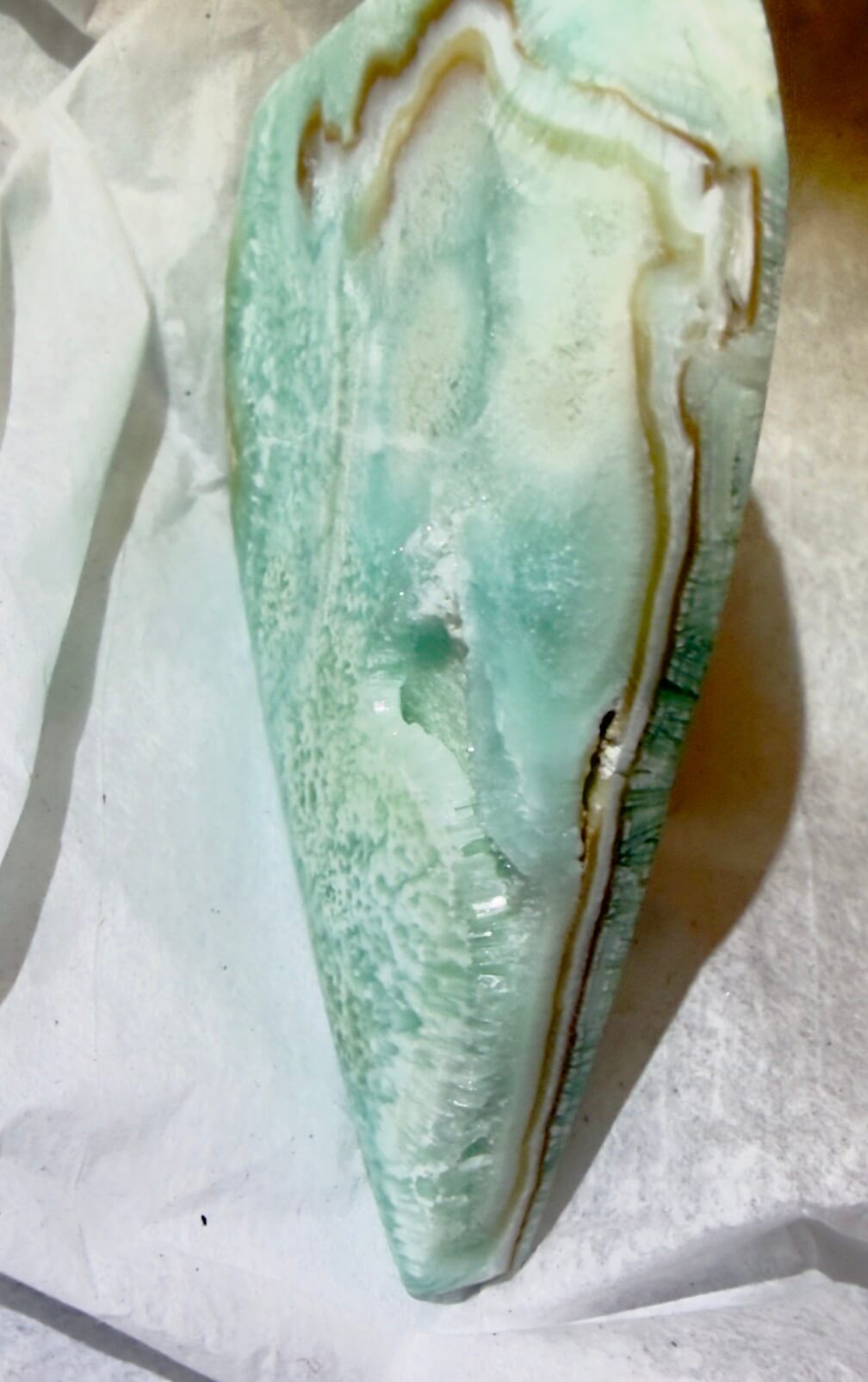 beautiful close up side view of Caribbean calcite freeform showing lamela or banding of blue calcite and aragonite minerals