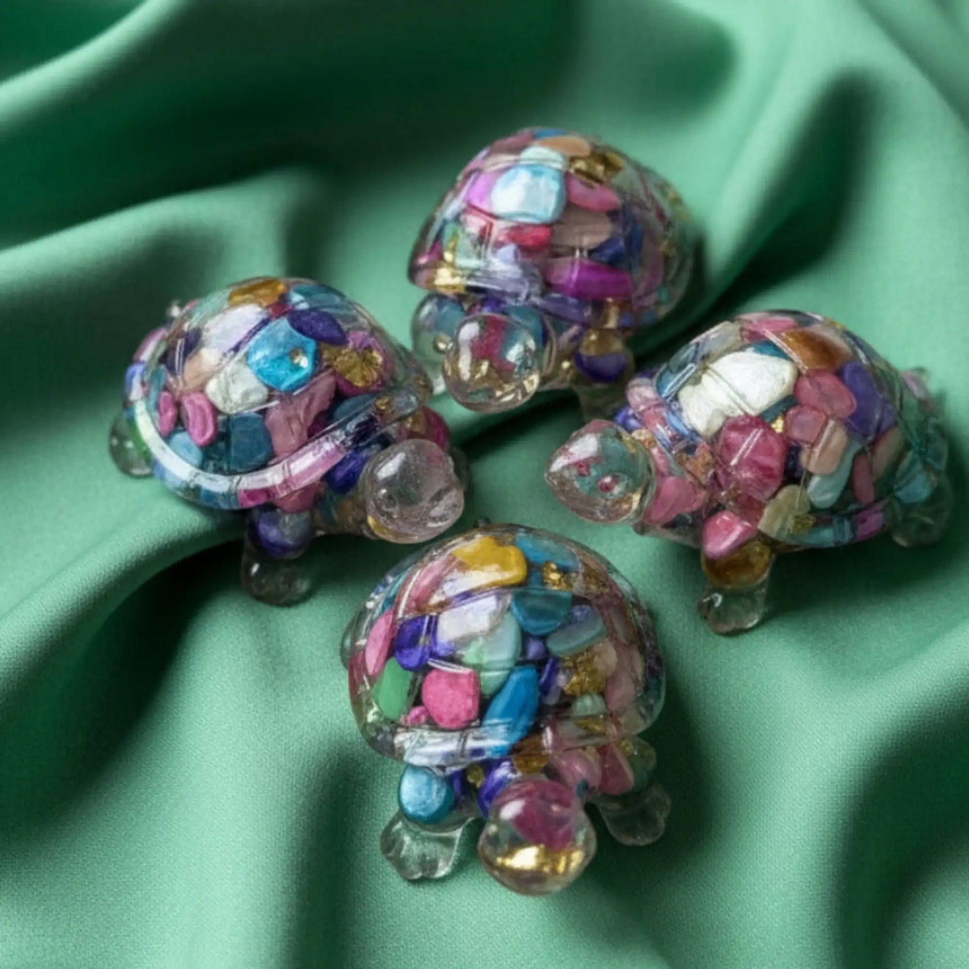 top of mini turtles that are dyed agate filled resin critters. colors resemble carnival glass mixed bright colors, pink, green, yellow, blue. figurine has metal chips also gold tone 