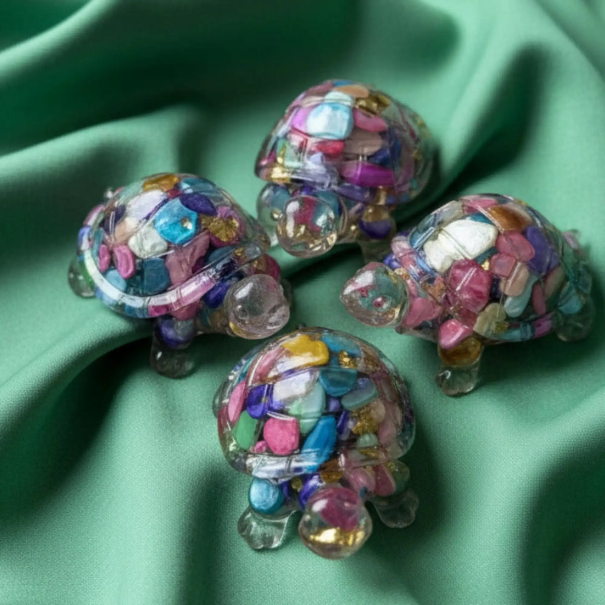 top of mini turtles that are dyed agate filled resin critters. colors resemble carnival glass mixed bright colors, pink, green, yellow, blue. figurine has metal chips also gold tone 
