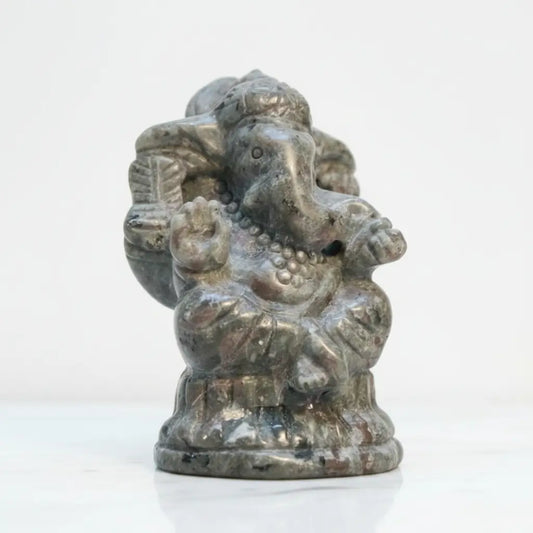A small carved statue of Ganesha carved from UV reactive Yooperlite Stone