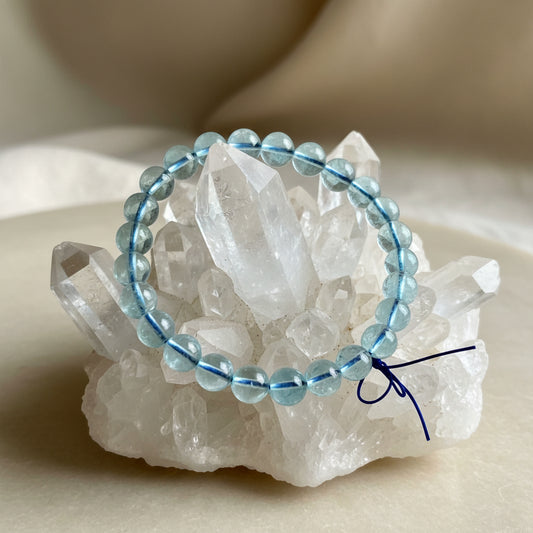close up of an aquamarine 9 mm bracelet on a rock cluster