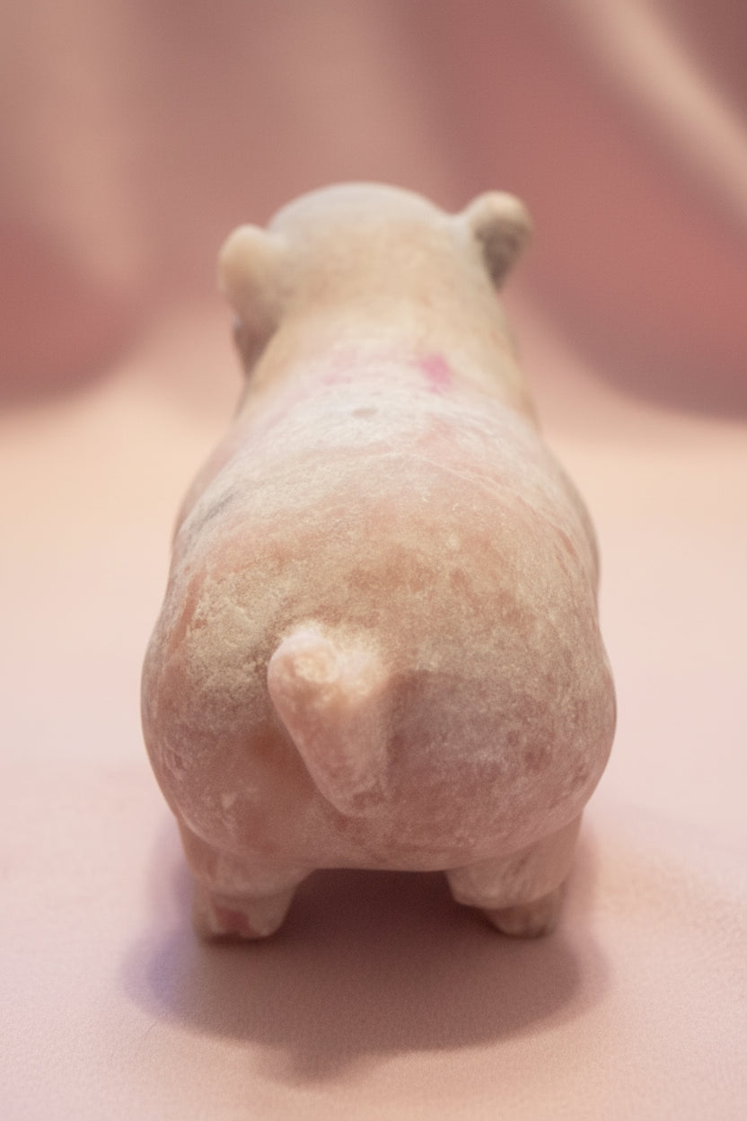 Cute rear view of pink calcite carved pig showing the beautiful pink and off white 
