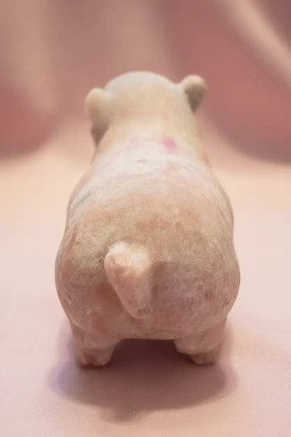 Cute rear view of pink calcite carved pig showing the beautiful pink and off white 