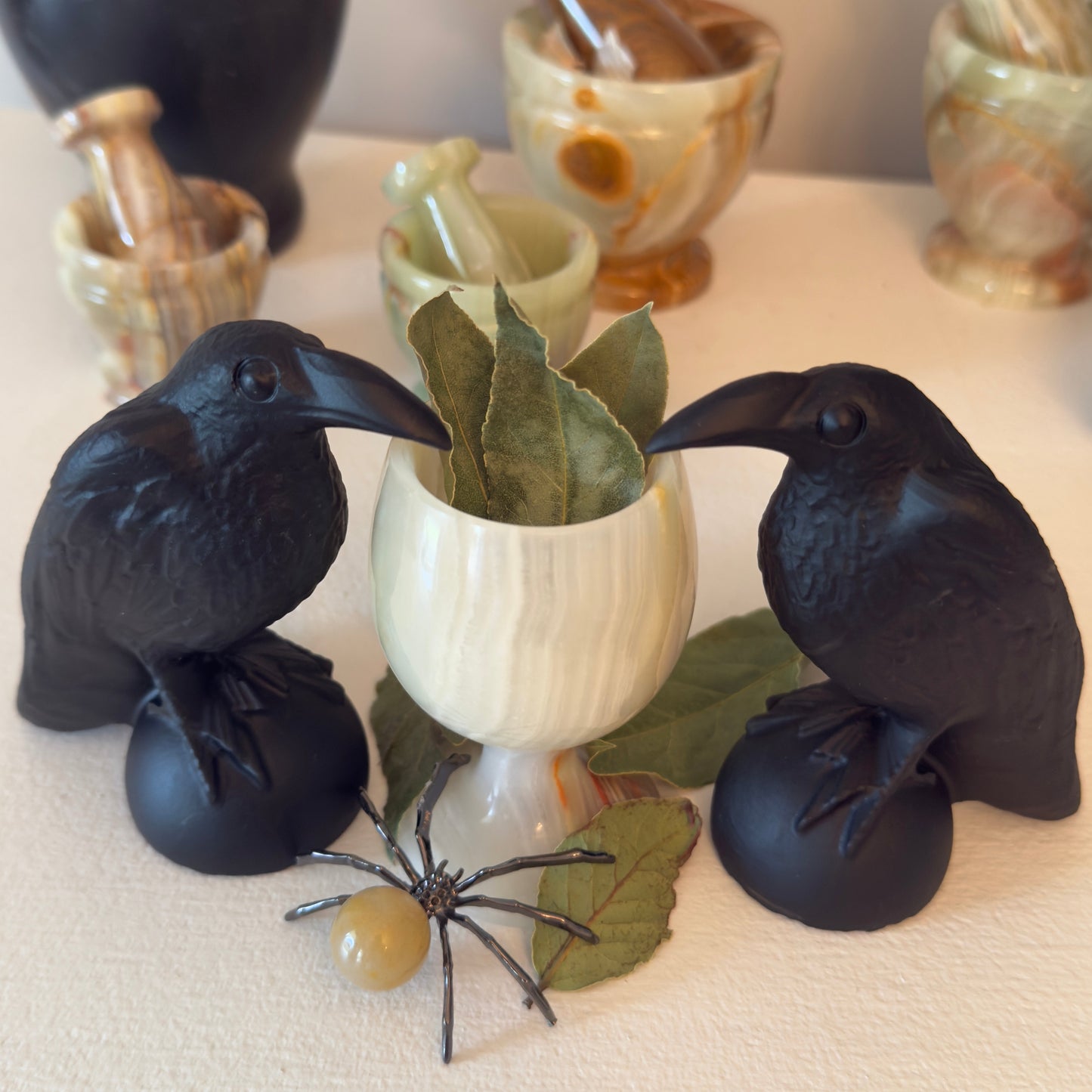two black obsidian raven carvings with a jade chalice herbs 