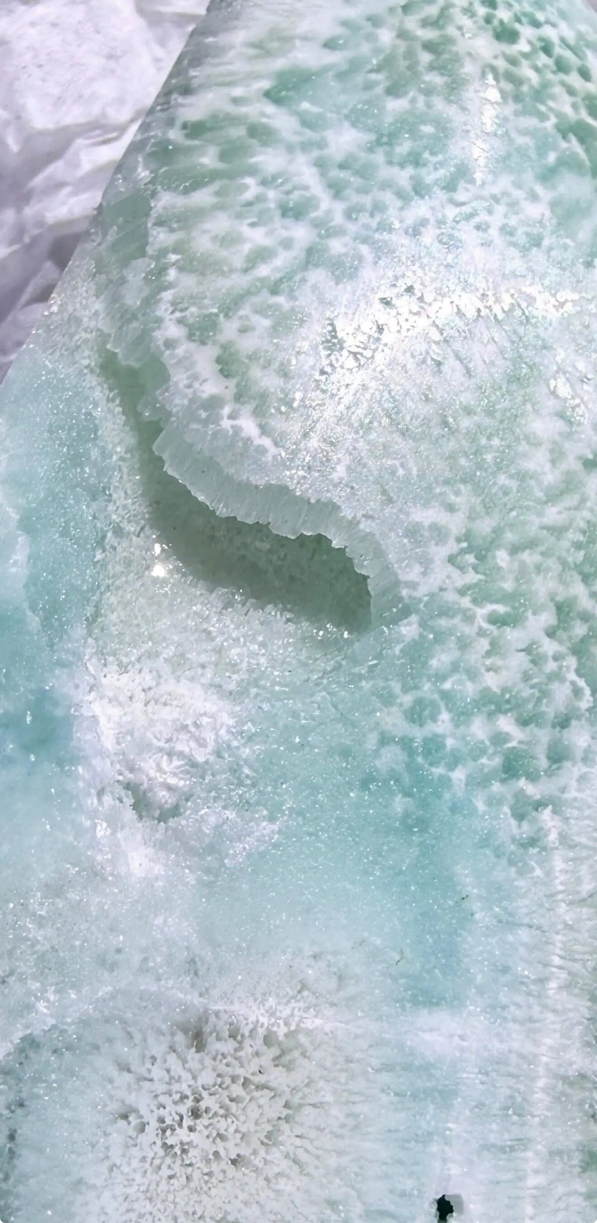 close up of caribbean calcite freeform druzy pocket. close up of the calcite rosette bottom of specimen