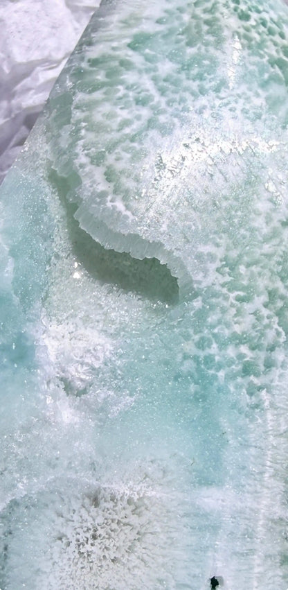 close up of caribbean calcite freeform druzy pocket. close up of the calcite rosette bottom of specimen
