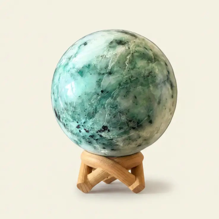 Close up chrysocolla in quartz sphere blues and white conchoidal fractures